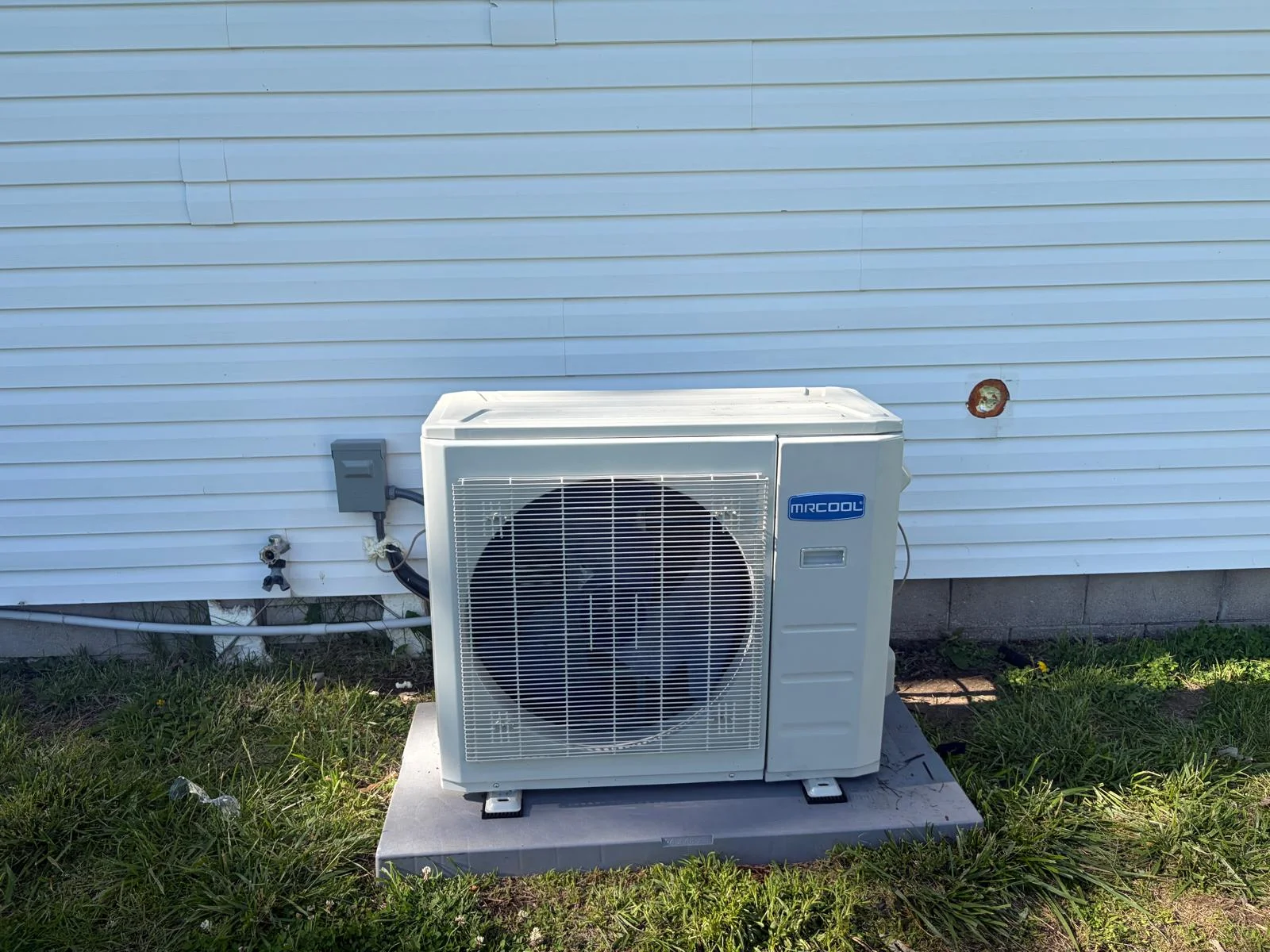 MrCool residential heat pump condenser unit installation on pad